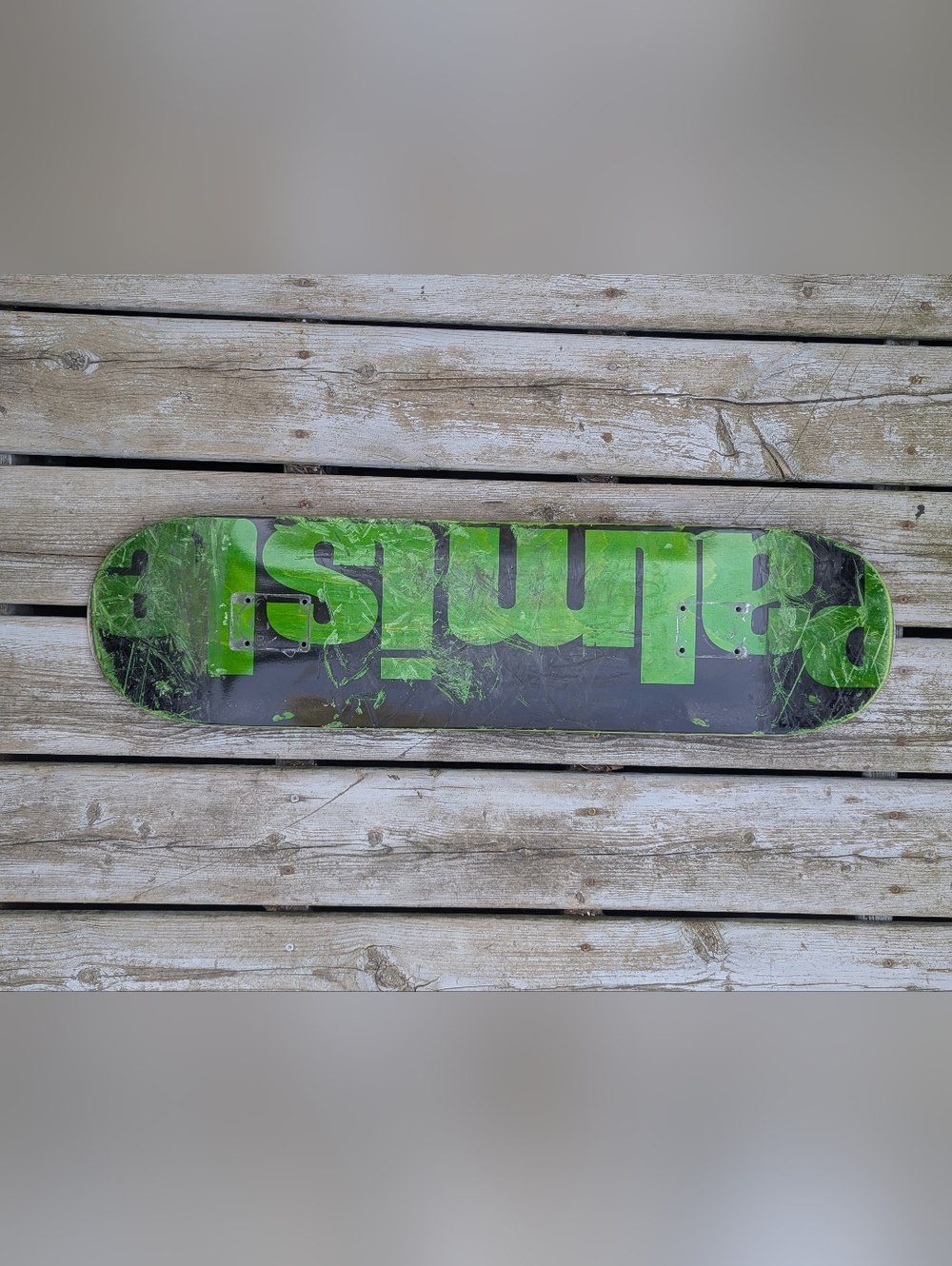 Green and Black Skateboard Deck with Bold Graphic